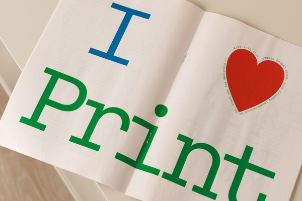 Inside spread of mini newspaper with “I ❤️ Print” in large text.